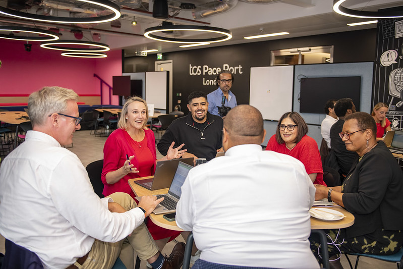 People gathered around tables at a community skills workshop